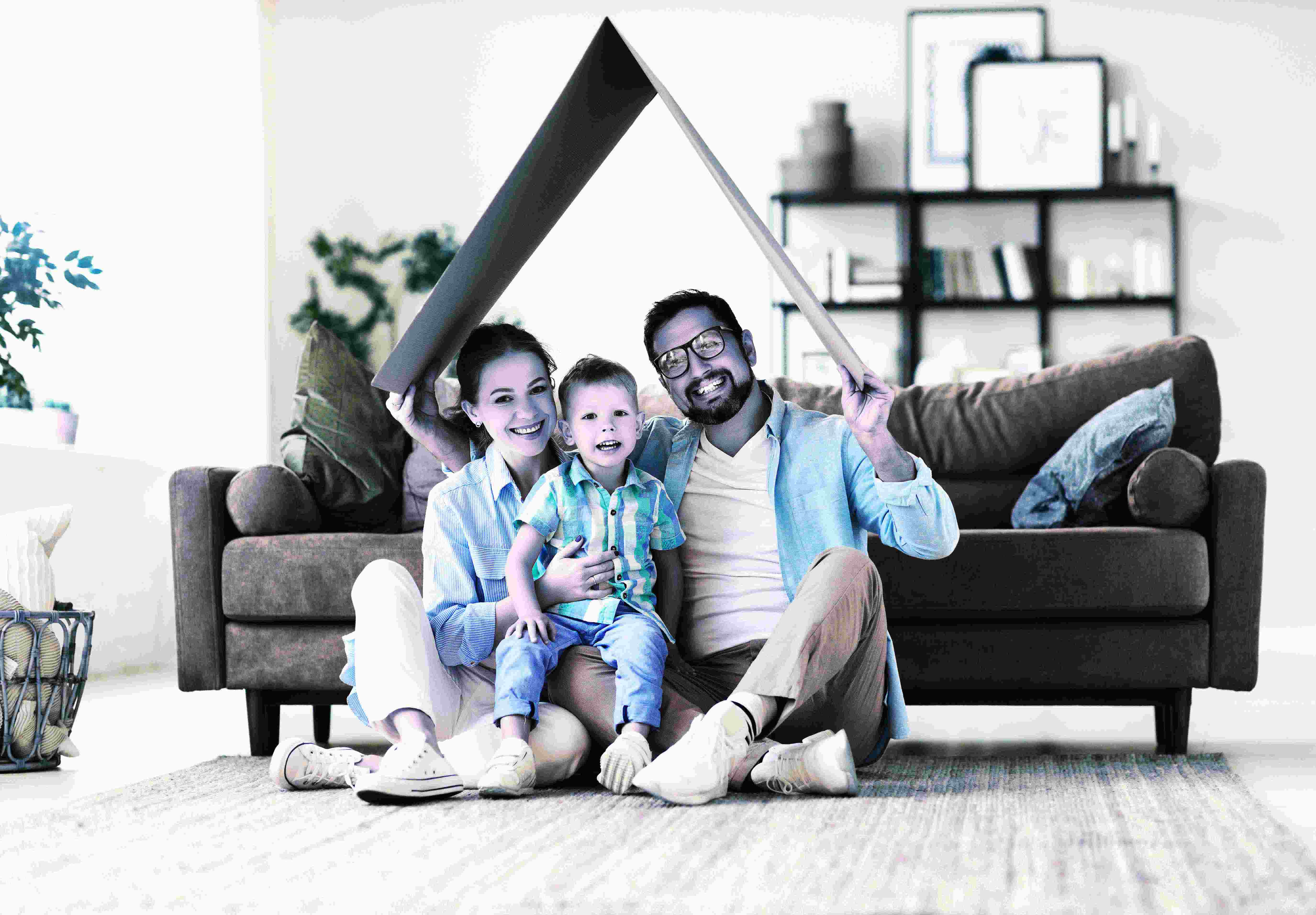 Happy couple in front of their new home